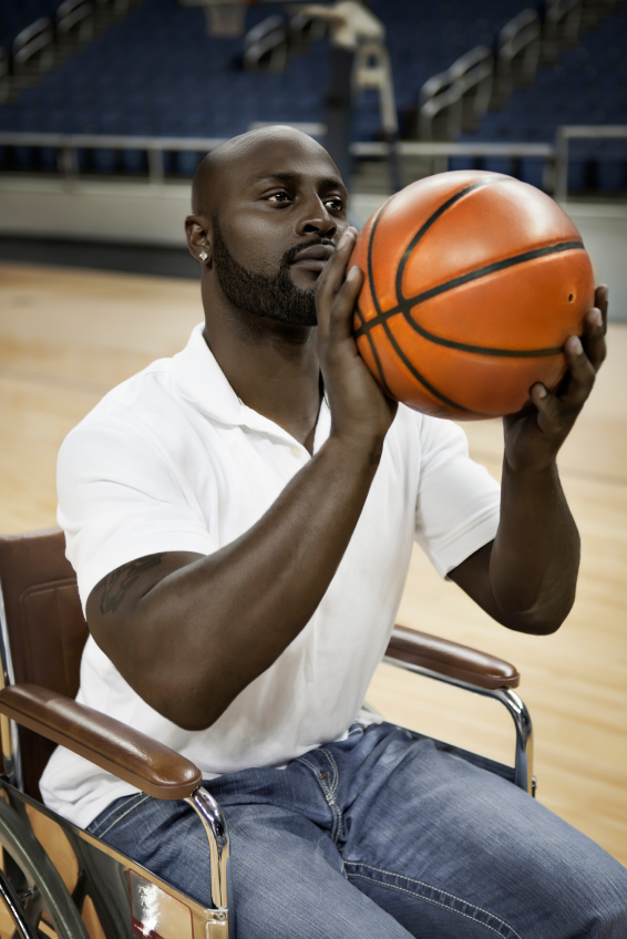 A wheelchair basketball player posts up for a free throw during a practice.