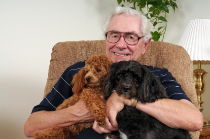 A senior gentleman in a lift chair with his dog.